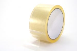 Aroll of clear packing tape, isolated on white background.