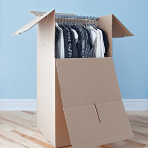 Wardrobe box with black and white clothing, prepared for transportation.